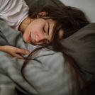 Young woman sleeping in bedroom