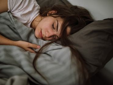 Young woman sleeping in bedroom