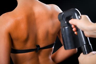 Woman body paint with airbrush in professional beauty salon